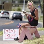 Bus rider gets in a little protest while waiting